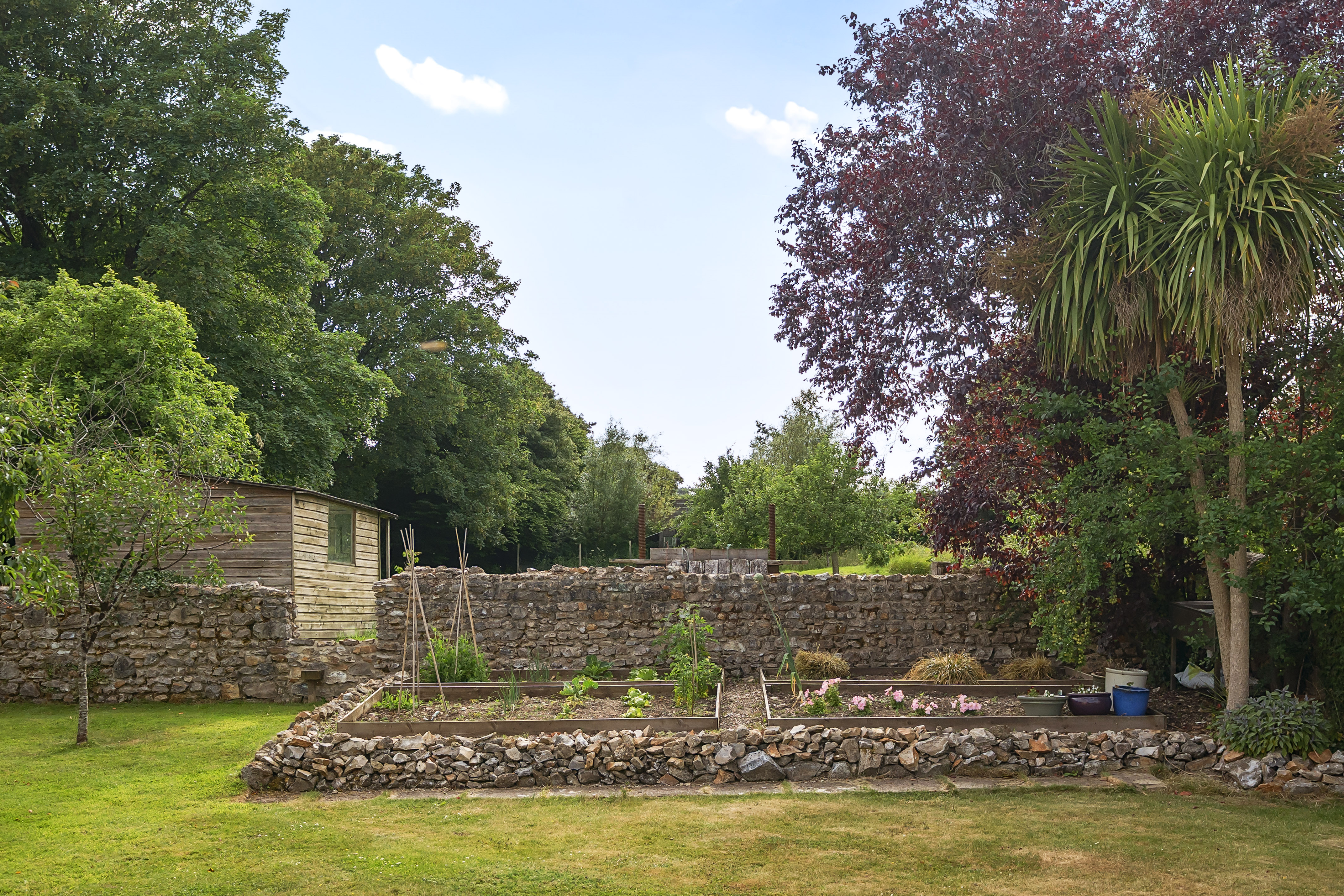 The grounds at Lakehayes — stream, paddock and the Tudor farmhouse
